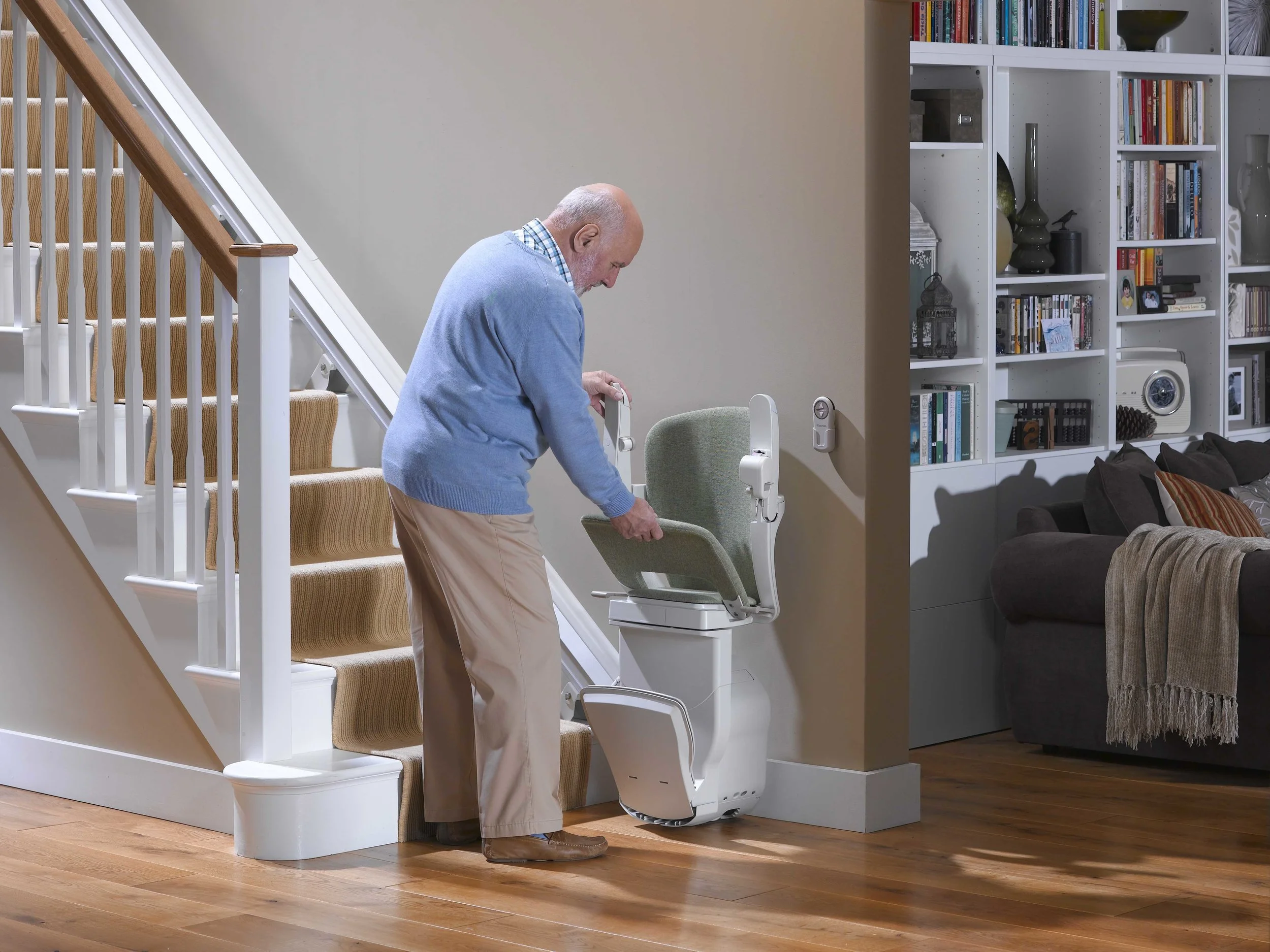 Reconditioned straight stairlift with seat folded flat against the wall