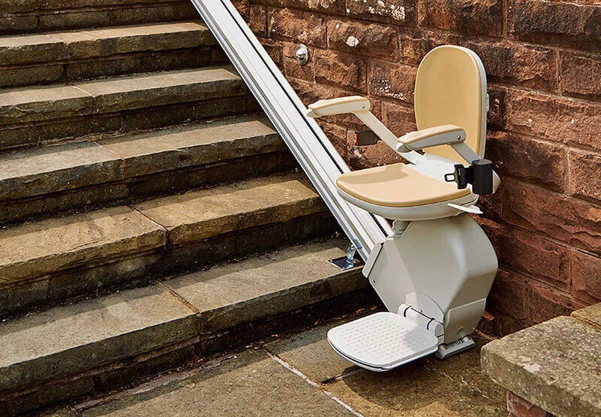 Outdoor stairlift installed on external steps leading to a front door