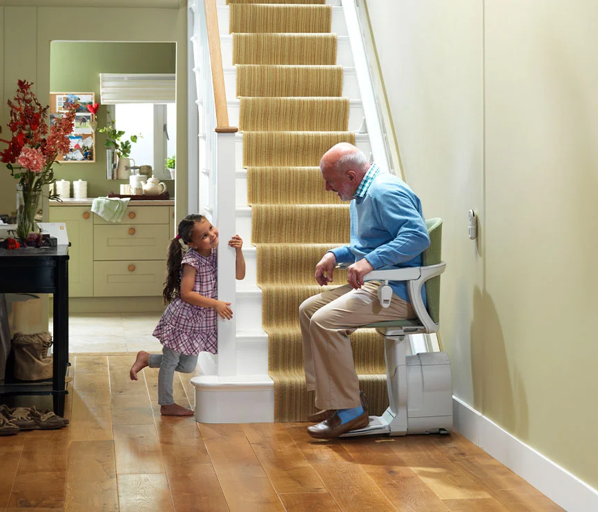 Family at home with a stairlift installed on their stairs